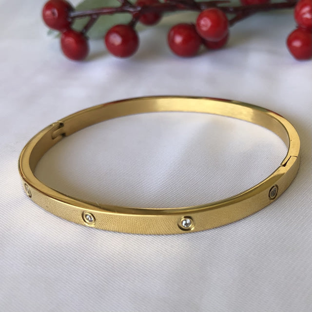 Pulsera esclava con circón 4 mm dorado de acero quirúrgico